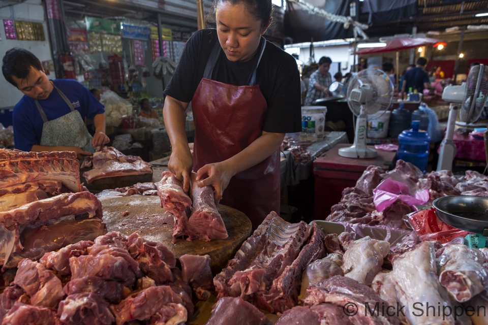 Butchering pork at a market stall Vientiane, Laos