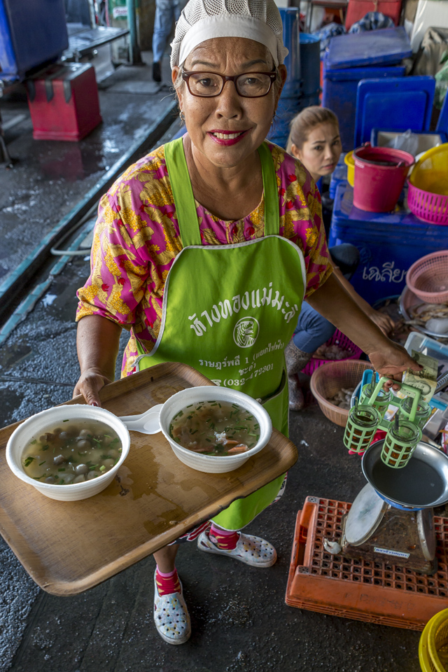 Delivering breakfast in the fresh market, Cha Am, Thailand