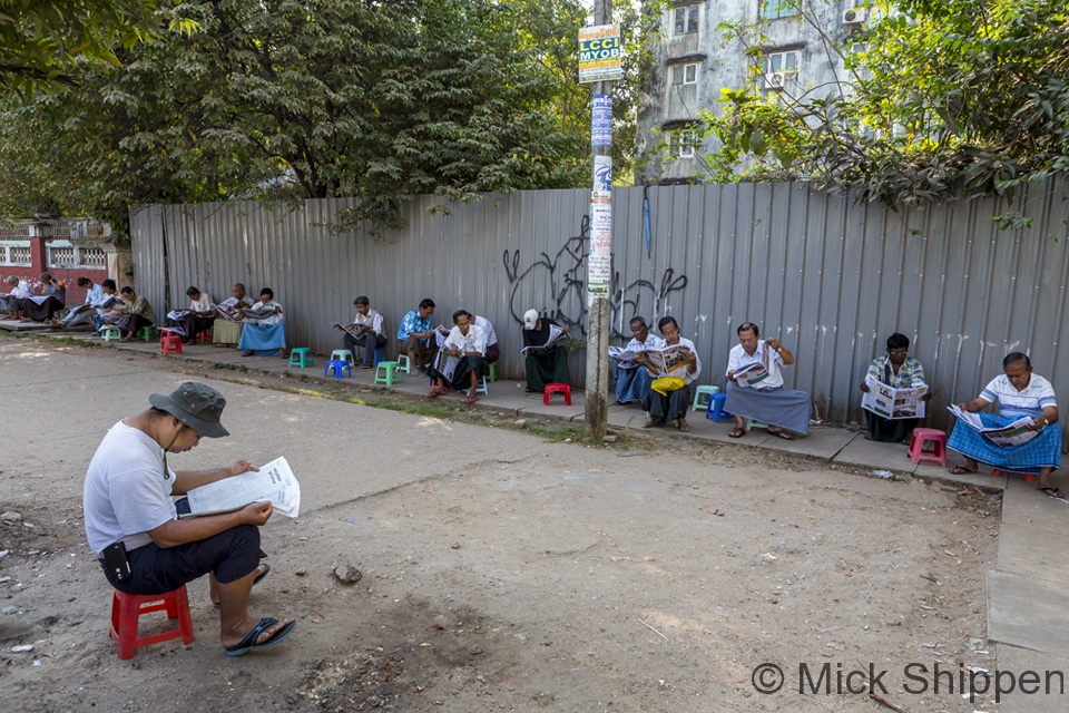 Reading the morning paper, Yangon, Myanmar