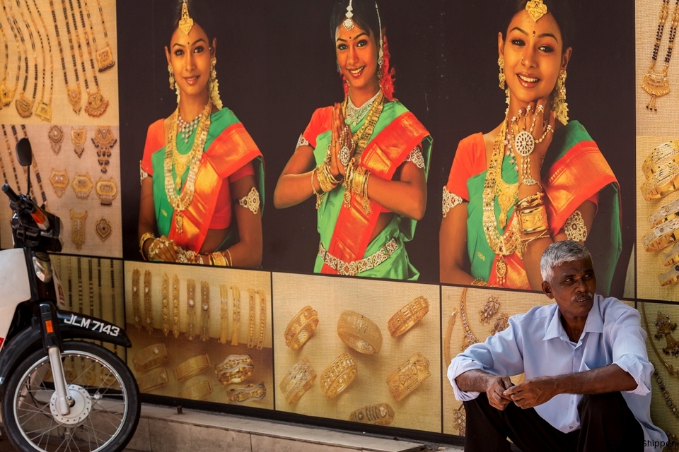 Indian-Malaysian man sitting in front of a shop in Masjid India, Kuala Lumpur, Malaysia.