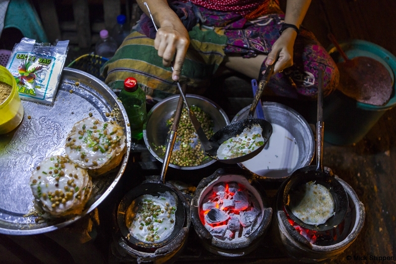Cooking breakfast dosas in Yangon, Myanmar.