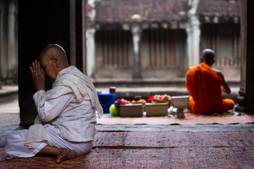 Buddhist nun praying at Angkor Wat, Siem Reap, Cambodia.