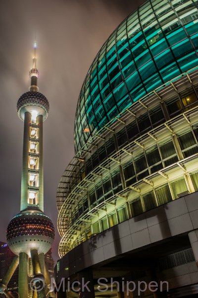 One of the glass domes of the Shanghai International Convention Center with the Oriental Pearl Tower in the background.