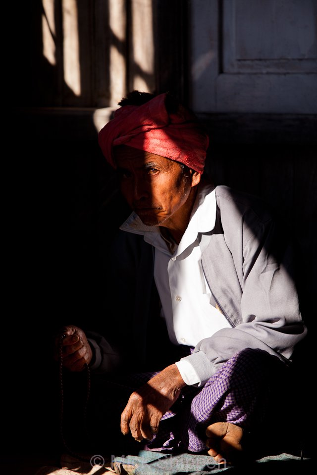 A man with prayer beads at Sattahtana Pagoda on the lake.