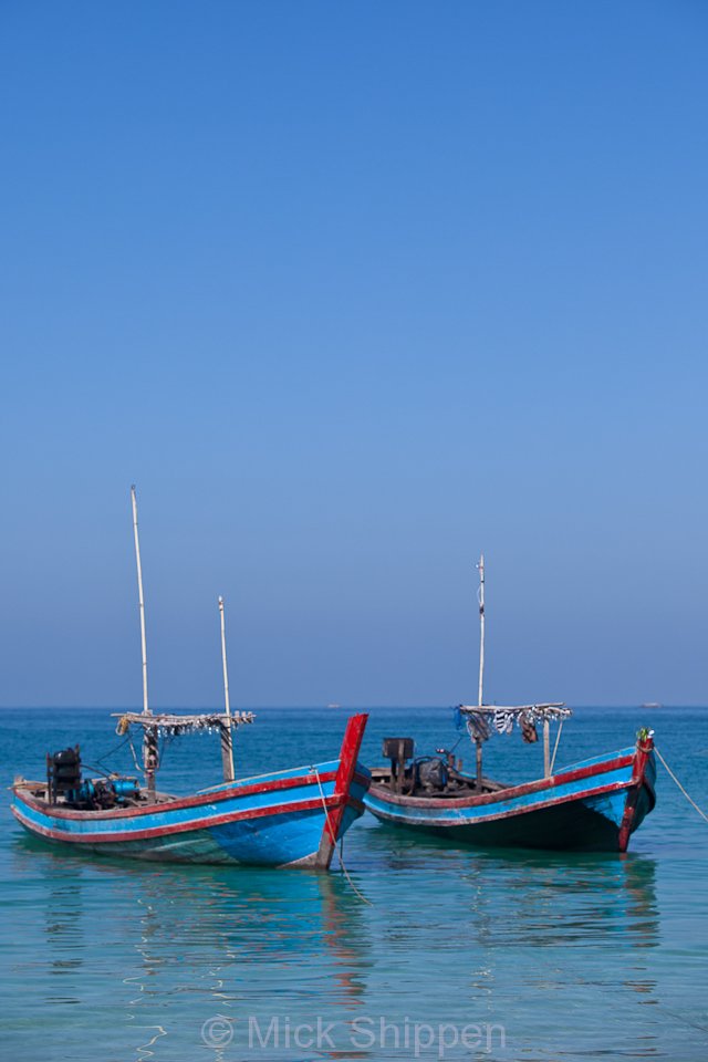 Fishing boats anchored off the beach. They head out to sea in the late afternoon, returning to shore with the catch at around 5a.m.