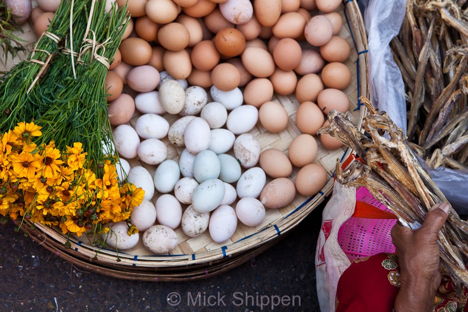 Flowers, eggs and dried fish for sale in one of the city's many street markets.