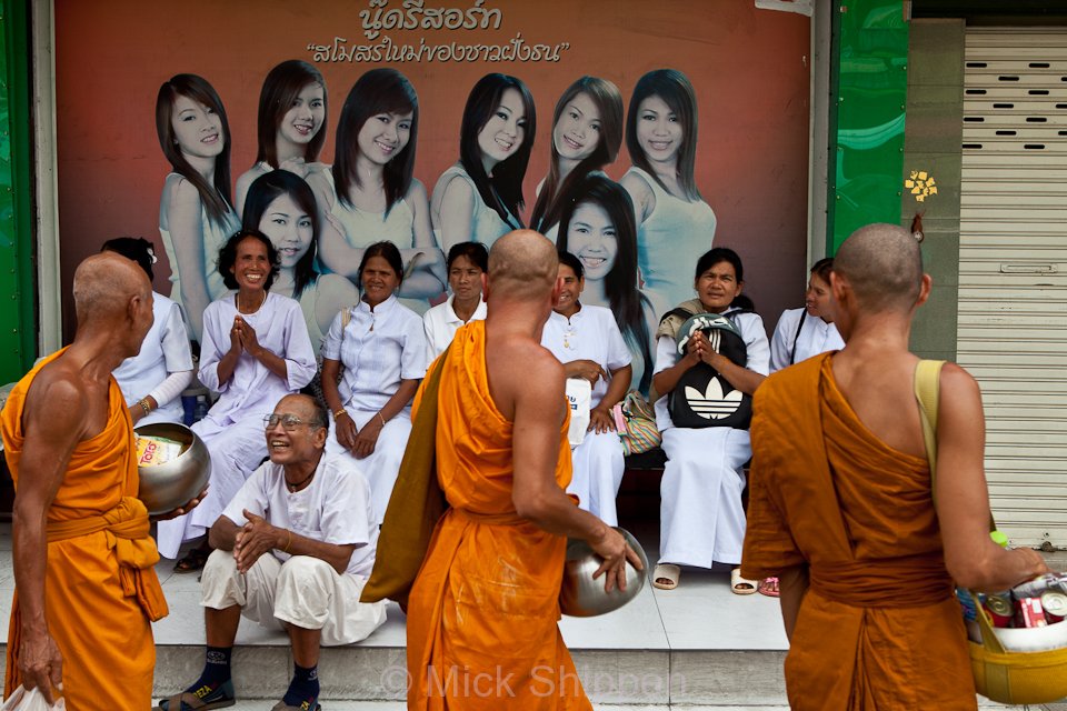 Buddhist monks walking passed a 'nude resort' in Bangkok